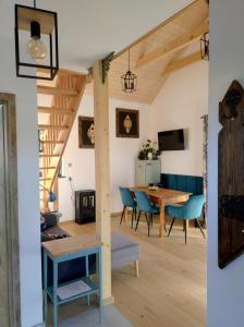 a living room and dining room with a table and chairs at Domek Zgredek in Żywiec