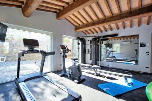 a gym with two treadmills and a treadmill at Villa Acquaviva with Panoramic, Private Pool and Gym - by PosarelliVillas in Panicale