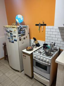a kitchen with a stove and a refrigerator at "La Violeta" casa con jardín y cochera, San Pedro in San Pedro +26 photos