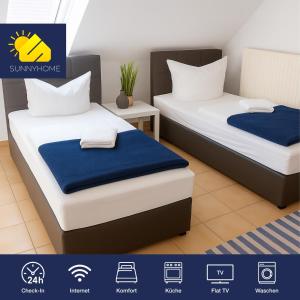 two beds in a room with blue and white at SUNNYHOME Monteurwohnungen und Apartments nahe Regensburg in Obertraubling
