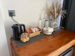 a wooden table with a coffee maker and bottles on it at Mountain Bliss - Ingiriya in Ingiriya +11 photos