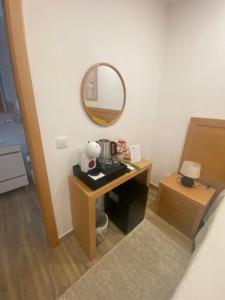 a room with a table with a sink and a mirror at Vivenda Por do Sol in Couço