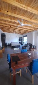 a living room with a wooden table and blue chairs at Loft Moderno in Viedma