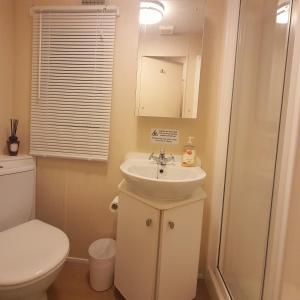 a bathroom with a sink and a toilet at Lady's Mile in Dawlish Warren