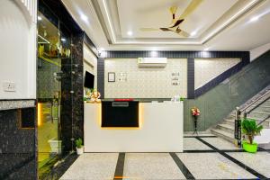 a lobby with a white counter and a ceiling at Airport Hotel Dream World - Offering Free Airport Drop in New Delhi