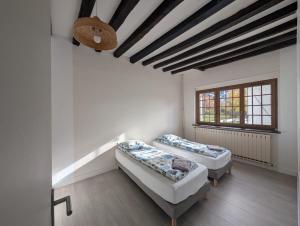 a room with two beds and a window at Crazy Villa Etisseaux 45 - Heated pool - Volley court - 1h30 Paris - 45p in Saint-Maurice-sur-Aveyron +26 photos