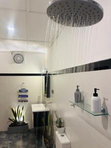 a white bathroom with a sink and a toilet at Mountain Bliss - Ingiriya in Ingiriya