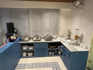 a kitchen with a counter with a stove top oven at NE Heritage Residency in Guwahati