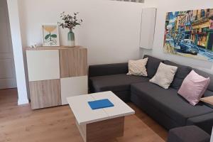 a living room with a couch and a table at Peaceful house in the heart of Boutonnet in Montpellier