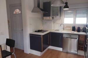 a kitchen with blue cabinets and a sink at Peaceful house in the heart of Boutonnet in Montpellier