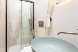 a bathroom with a sink and a glass shower at Marina Home - Luxury Apartament in Stazione Catania Porto +19 photos