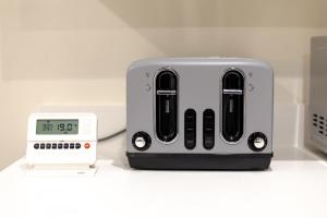 a toaster and an alarm clock on a counter at The Townhouse Collection 2BR Close To City Centre in Cardiff