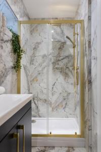 a shower with a glass door in a bathroom at The Townhouse Collection 2BR Close To City Centre in Cardiff