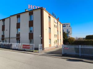 a building with a sign on the top of it at Hotel Eden 24h in Rzeszów