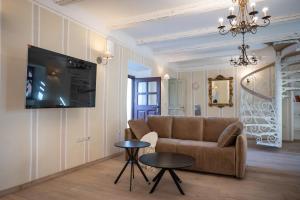 a living room with a couch and a table at Apartmaji Hiša kranjske čebele in Višnja Gora