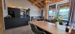 a kitchen and dining room with a wooden table at Almchalet Alpenglück in Sankt Lambrecht