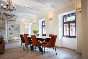 a dining room with a table and chairs at Apartmaji Hiša kranjske čebele in Višnja Gora