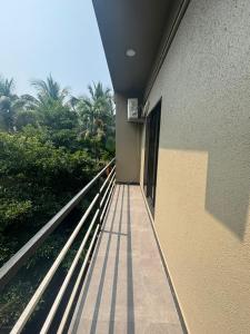 a balcony of a building with a view of trees at Samudra Courtyard in Kashid +8 photos