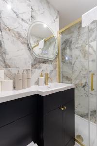 a bathroom with a sink and a mirror at The Townhouse Collection 2BR Close To City Centre in Cardiff +104 photos