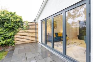 a house with sliding glass doors on a patio at The Townhouse Collection 2BR Close To City Centre in Cardiff
