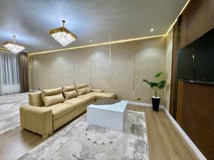 a living room with a couch and a table at Town House in Samarkand