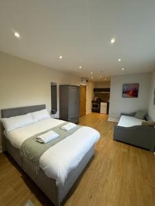 a large bedroom with a large bed and a kitchen at Newcastle Executive Stays in Newcastle upon Tyne