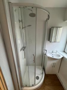 a bathroom with a shower and a toilet and a sink at Newcastle Executive Stays in Newcastle upon Tyne