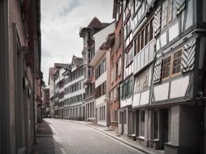 an empty street in a city with buildings at normalkonsum - premium apartments in St. Gallen