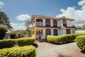 a house with hedges in front of it at Meru Villa Arusha in Olmotoni