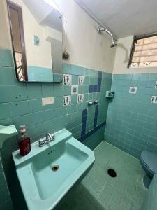 a bathroom with a sink and a mirror at Casona el Sol in Veracruz