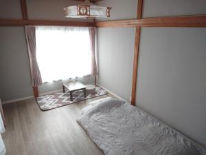 Postel nebo postele na pokoji v ubytování ゲストハウス寄泊 ー女性のための 香取のお家ー Guesthouse Yohaku