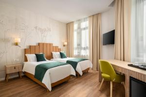 Ένα ή περισσότερα κρεβάτια σε δωμάτιο στο Hotel Epica