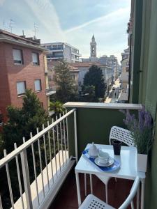 a white table and chairs on a balcony with a view at B&B Altea in Pescara