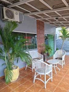 a group of chairs and tables on a patio at Residencial Celedone in Boa Vista