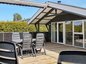a patio with chairs and a table on a deck at Tranquil Oasis near Golf Course-By Traum in Hals