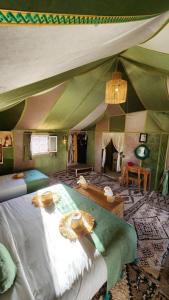 a bedroom with a large bed in a tent at Unique Luxury Camp in Merzouga +43 photos