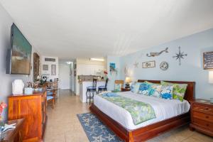 a bedroom with a bed and a kitchen at Lahaina Shores 428 · LS 428 Dream Vacation Studio by the Beach a in Lahaina
