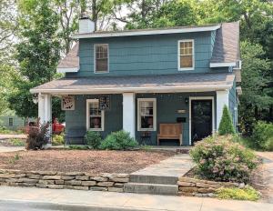 a blue house with a bench in front of it at Hot Tub 3 Kings Close To Everything in Bloomington