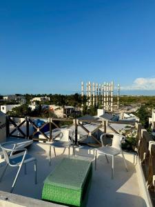 a group of chairs and a bench on a roof at Beach Trendy Lux Villa in Chicxulub