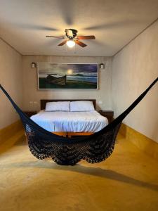 a bedroom with a bed with a hammock in it at Beach Trendy Lux Villa in Chicxulub