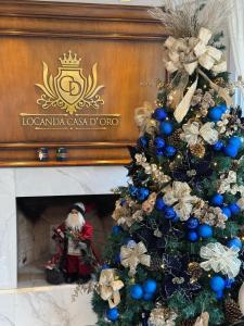 グラマドにあるHotel Locanda Casa D'Oroの暖炉前のクリスマスツリー