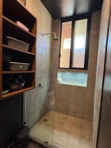 a bathroom with a shower with a glass door at Beach Trendy Lux Villa in Chicxulub +14 photos