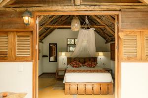 a bedroom with a bed in a room with wooden ceilings at Cabañas Tucan Eco Hotel in Capurganá