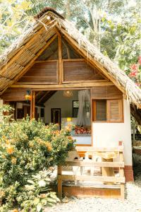 a small house with a thatched roof at Cabañas Tucan Eco Hotel in Capurganá