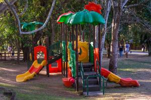 a playground in a park with colorful playground equipment at Kruger Park Lodge Unit No 237 in Hazyview