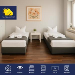 a bedroom with two beds and a table at SUNNYHOME Monteurwohnungen und Apartments in Schwandorf in Schwandorf in Bayern