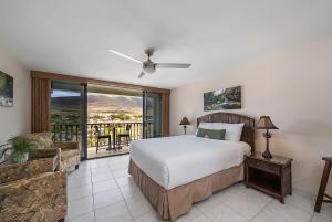a bedroom with a bed and a balcony at Lahaina Shores 306 · LS 306 Dream Maui Studio by the Beach Pool in Wainee +49 photos