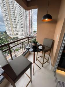 una stanza con tavolo, sedie e balcone di Ap Setor universitário a Goiânia