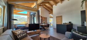 a living room with a couch and a tv and a table at Almchalet Alpenglück in Sankt Lambrecht