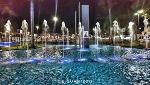 a fountain in the middle of a city at night at Grande Hotel Amparo in Amparo